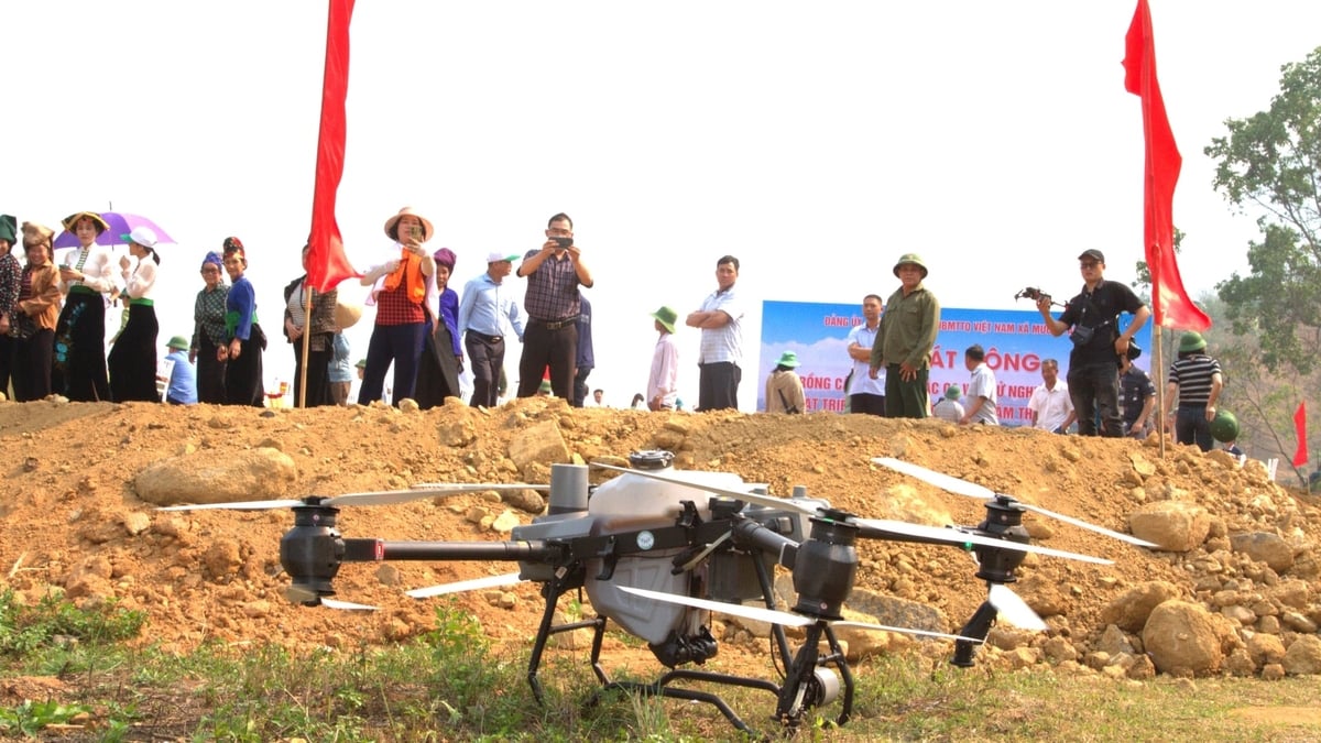 Đại biểu và người dân theo dõi hoạt động thử nghiệm drone tại bản Mánh Đanh, xã Mường Ảng. Ảnh: An Nhiên.